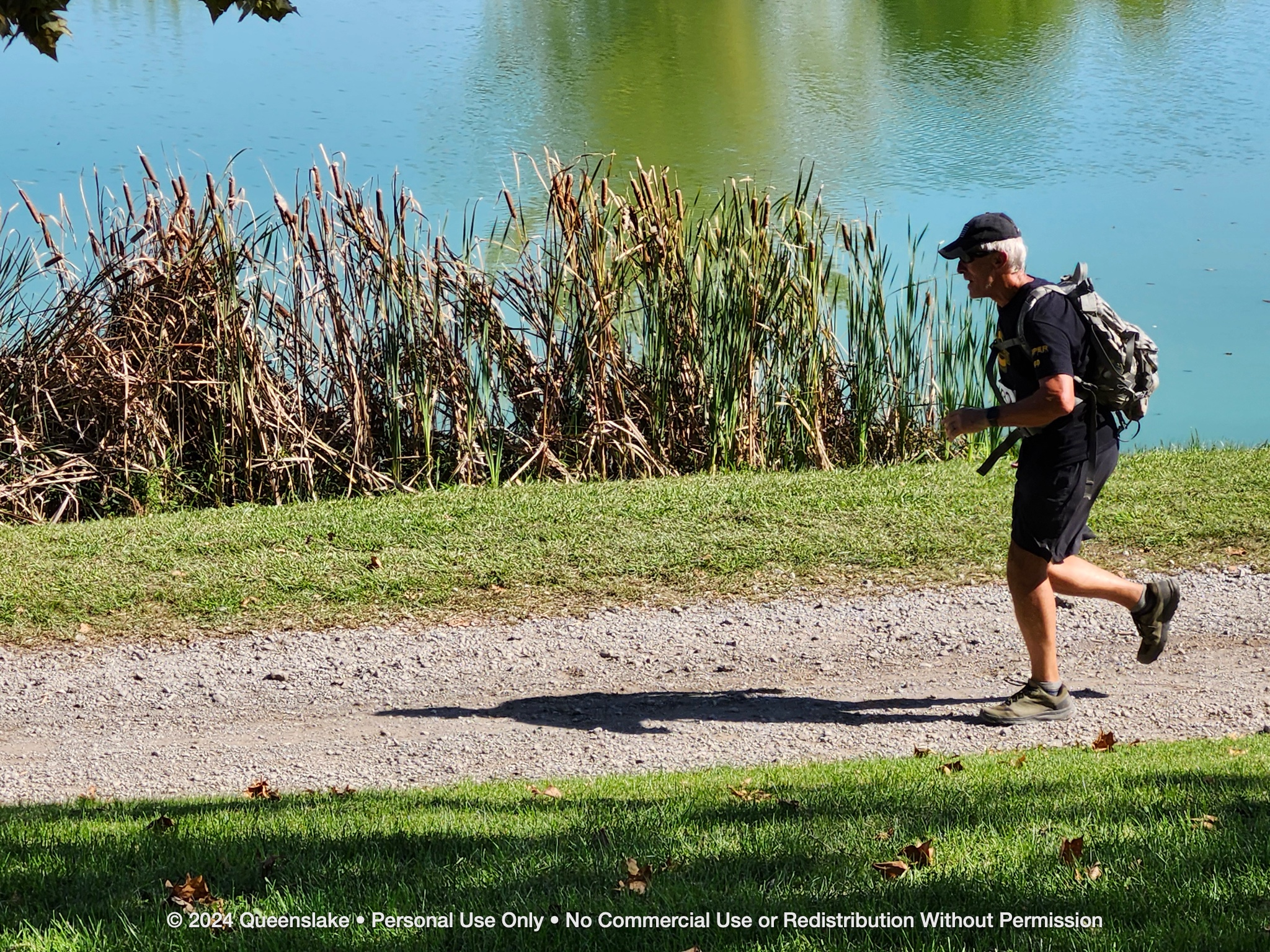 CW4 Dan Jollota rucking past the lakeside cattails on the Queenslake tactical trail.