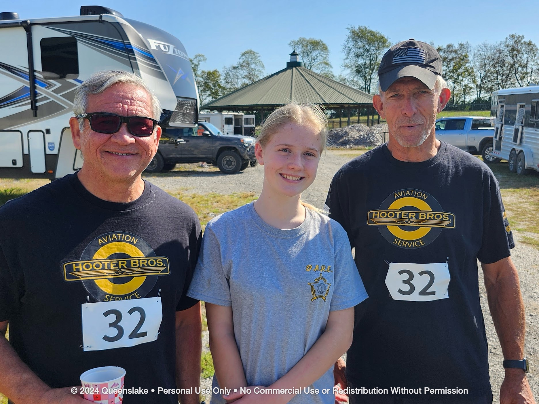 Dan Jollota and Mike Durant sharing a memorable moment with host John Chmela's daughter Hunter at Queenslake.