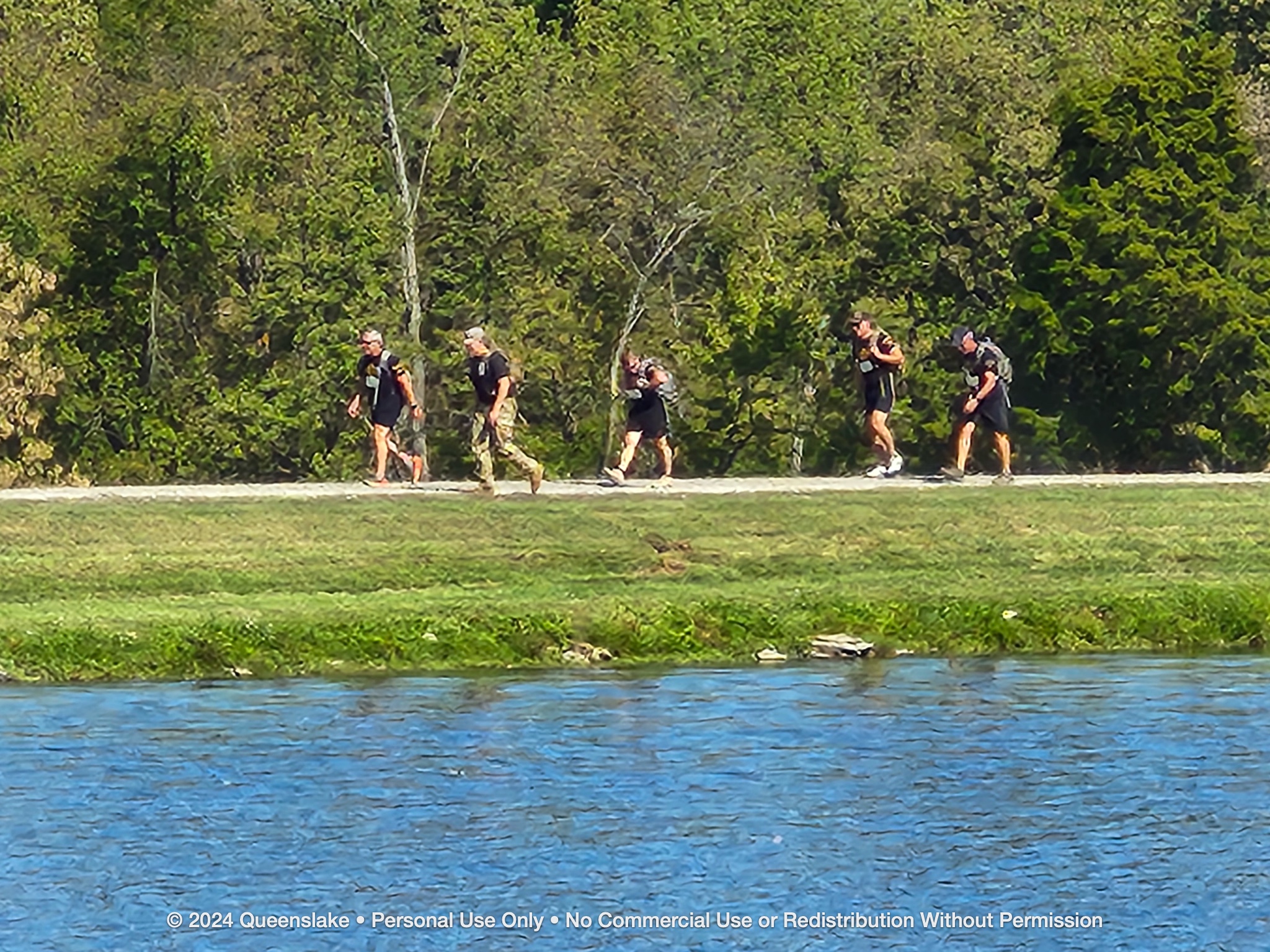 Team 32 rucking across the Queenslake earthen dam with Dan Jollota and Mike Durant pacing the column.