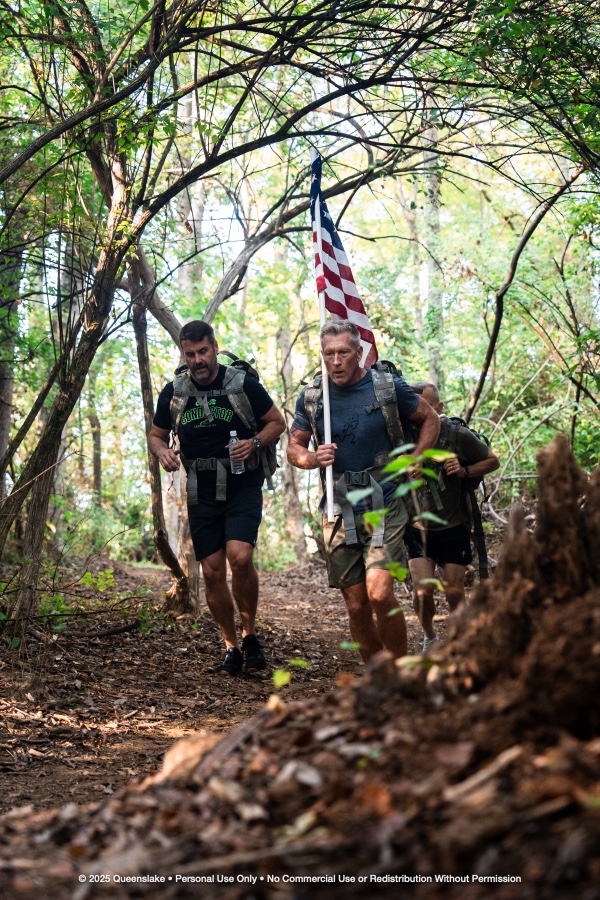 Athletes Powering Uphill Through Forest Timber Canopy with Flag