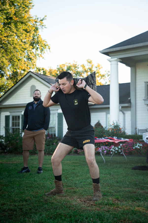 Front Close-up of Cadet in Combat Boots Performing Shouldered Sandbag Squats