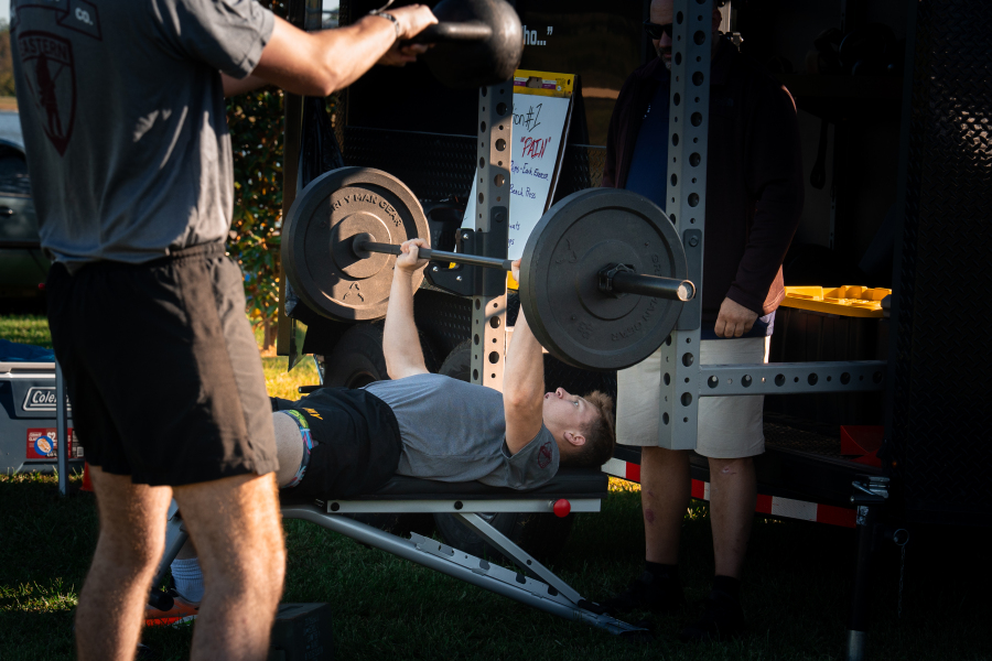 Station #1 PAIN Whiteboard with Barbell Bench Press and EKU Ranger Co. Kettlebell Swing