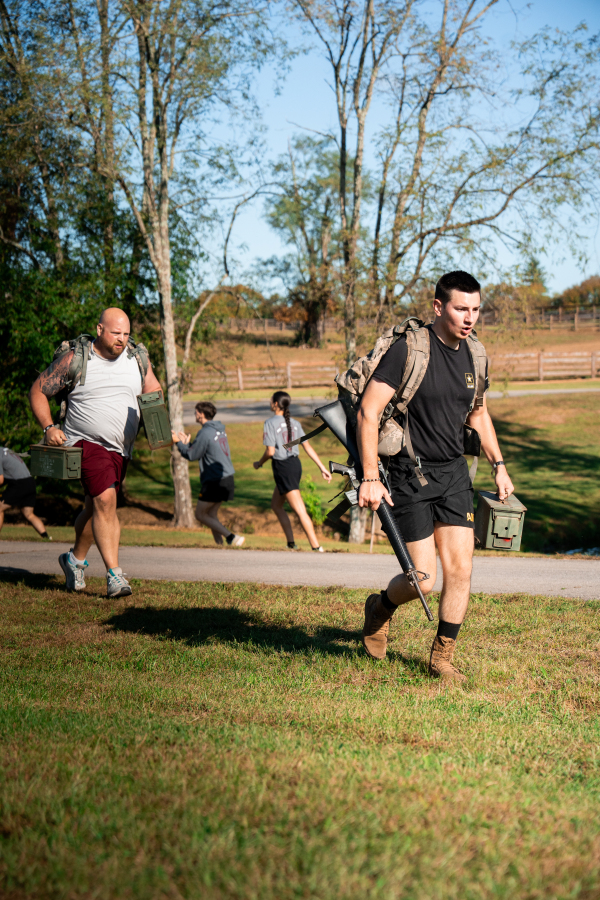 Athlete Rucking with Replica Combat Rifle & Ammo Can