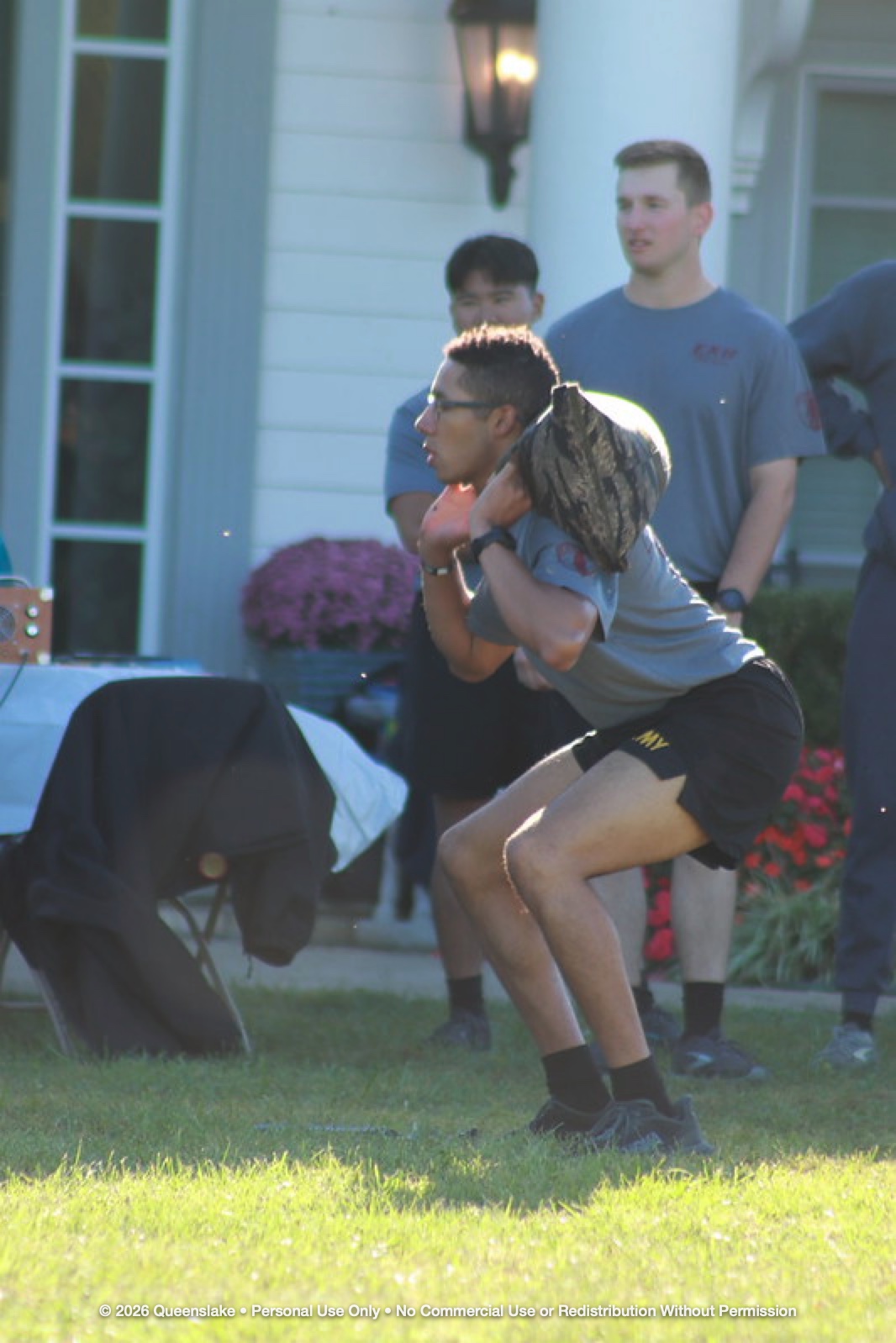 Close-up of Cadet Performing Deep Squats with Camo Sandbag on Shoulder